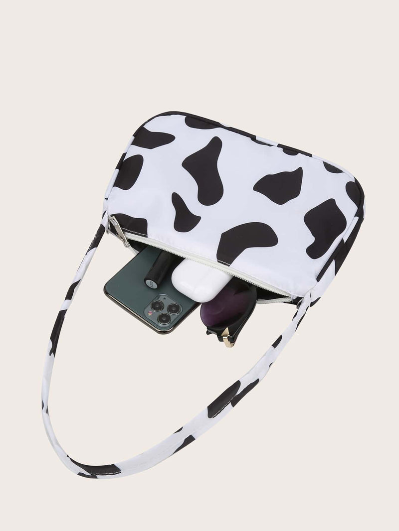 Bolso de hombro con dije de mariposa y estampado de vaca